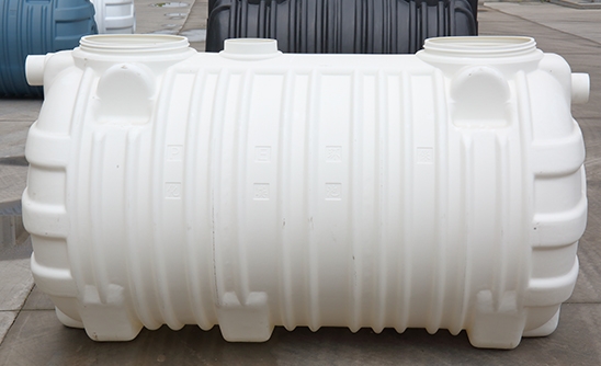What is the principle of the integrated three-cell septic tank?